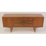 A 1960s Stonehill Furniture teak sideboard, having three central drawers flanked by twin cupboard