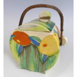 A 1930s Clarice Cliff Delicia Citrus pattern pottery biscuit barrel and cover, having a raffia swing