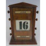 An Art Deco mahogany desk calendar, with adjustable month, date, and day of the week, 20.5 x 15cm