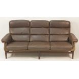 A 1960s Danish chocolate brown leather, suede upholstered and hardwood framed three-seater sofa,