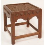 An Arts & Crafts joined oak square footstool, having interlaced tan leather inset top, raised on