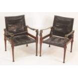 A pair of 1960s Danish Afrormosia teak framed open armchairs, having stitched black slung
