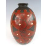 An African Art Deco period earthenware vase, painted with stylised trailing floral decoration in