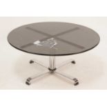 A 1960s smoky glass topped and chrome based circular coffee table, the upper and lower supports of