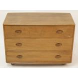 An Ercol 'Windsor' blond elm chest of three long drawers, raised on roller castors, h.65.5cm, w.91.