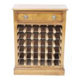 An oak and burr oak wine rack, having crossbanded top and frieze drawer above a 36 bottle capacity