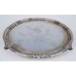 A George VI silver salver, of shaped circular form within a pie crust border, raised on three