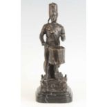 A bronze alloy figure, modelled as a Napoleonic drummer, on a stepped black marble base, signed