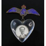 A WW II brass and enamelled R.A.F. sweetheart wing brooch, suspending a heart shaped perspex pendant