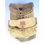 A House of Hardy cream canvas fishing bag with brown leather trim, having two exterior pockets,