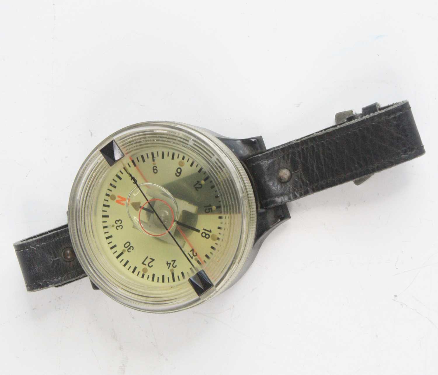 A WW II German Luftwaffe pilot's navigation wrist compass, Kadlec AK39 Fl 23235-1, on a black