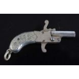 An early 20th century Austrian miniature working pin fire pistol, the nickel grips with foliate