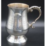 An Elizabeth II silver tankard, of bell shape with acanthus cappped C-scroll handle inscribed "
