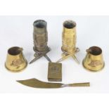 A pair of WW I trench art shell cases, each depicting a building in Ypes within a wreath, mounted on