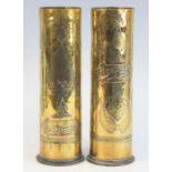 A pair of WW I German artillery shells, each inlaid with copper and white metal with further