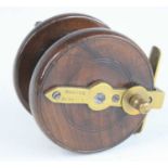 An early 20th century Hardy 3" mahogany centre pin fly reel, having twin handles and brass