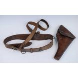 A WW I leather Sam Browne belt with brass fittings, together with a Webley brown leather holster. (