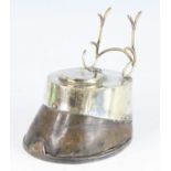 An Edwardian horse hoof inkwell, having a silver plated horse shoe mount and hinged lid with