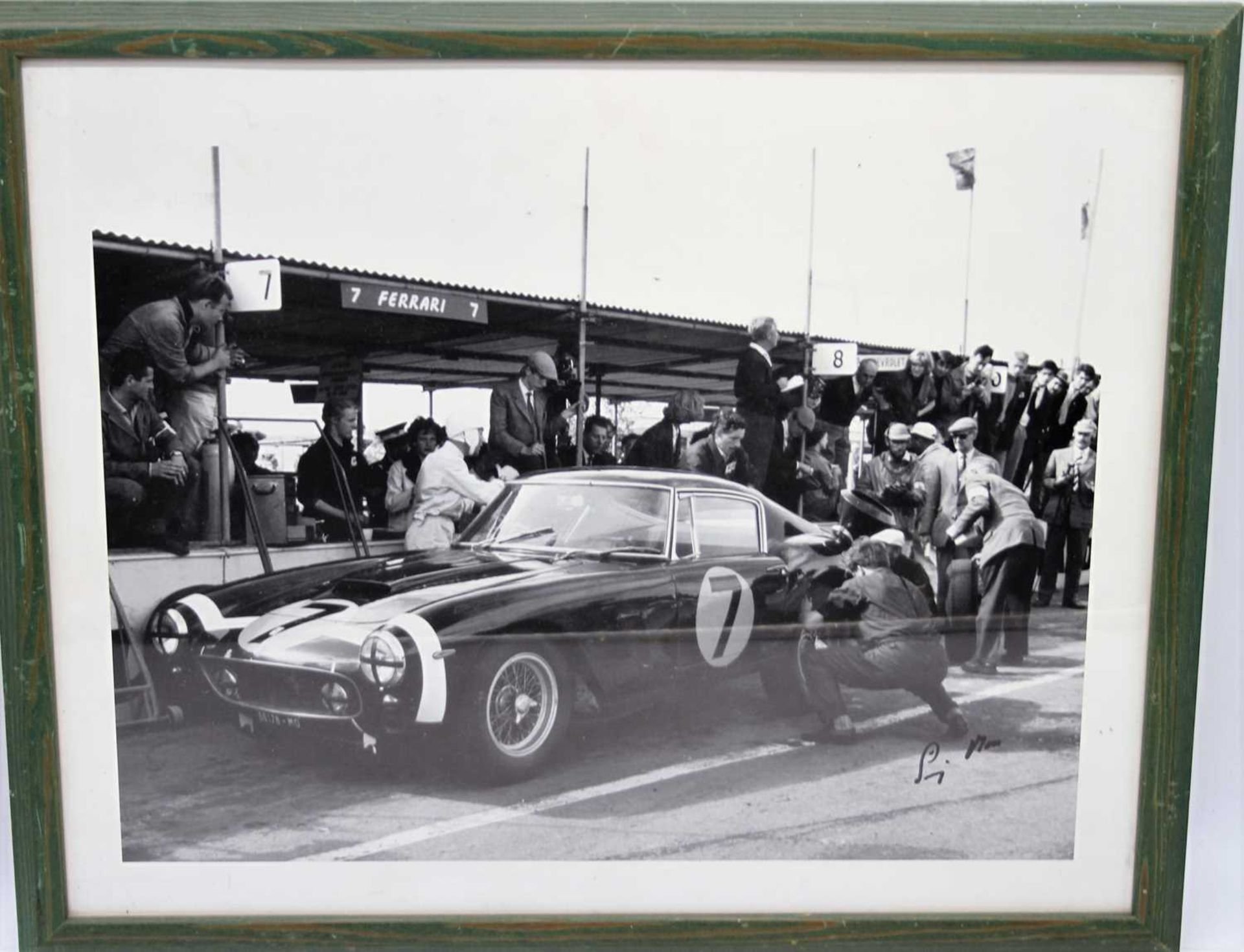 A signed photographic print of Stirling Moss in 1961 beside his SWB Ferrari 250GT, signed by Moss
