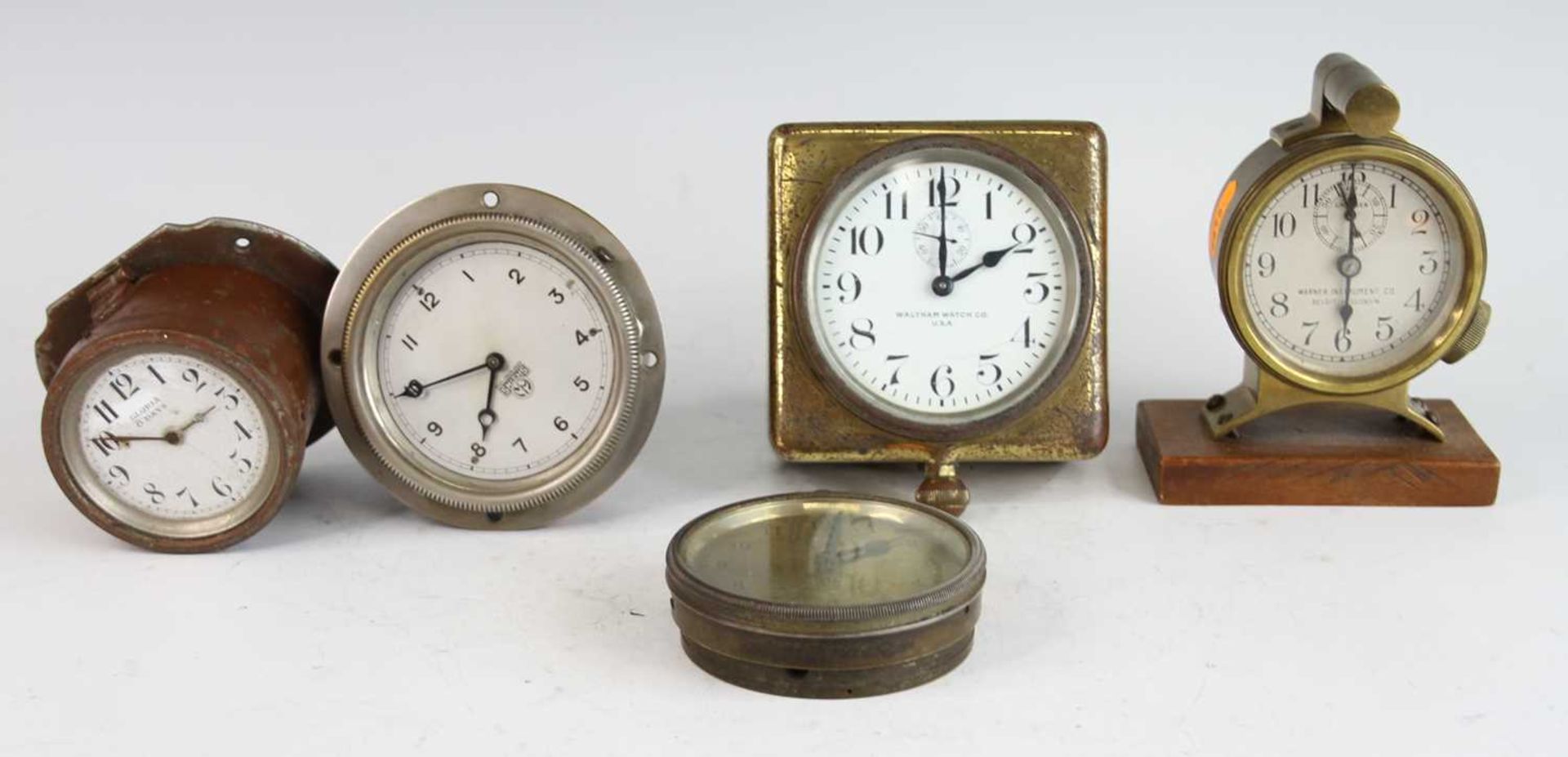 Five various mid-20th century car clocks, to include brass and timber mounted example by Warner