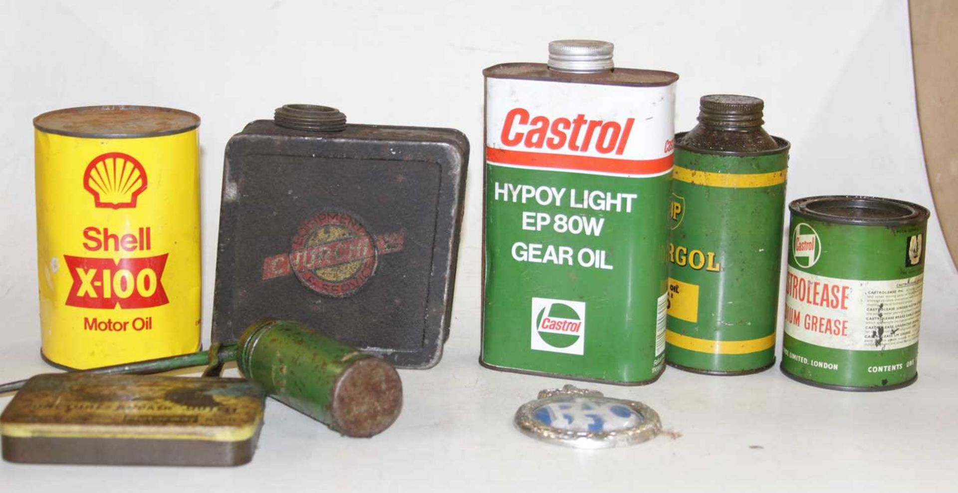 A cased set of three lamps, sundry oil cans, a Churchill vintage motorcycle fuel tank, unopened
