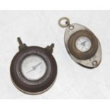 A miniature pocket compass, with inset loup, together with a miniature dashboard(?) compass (2)