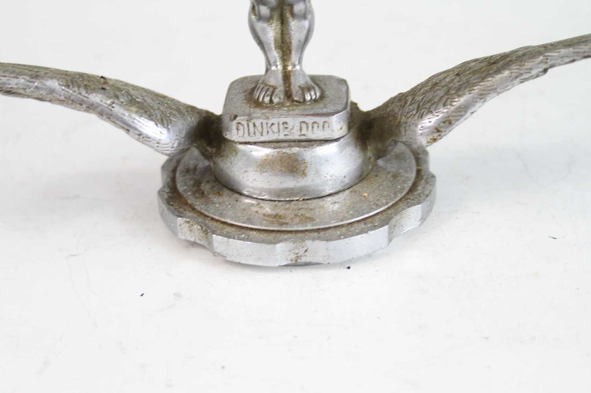 A vintage cast chromed metal car mascot of Dinky Doo, raised on winged and notched circular base, - Image 2 of 4