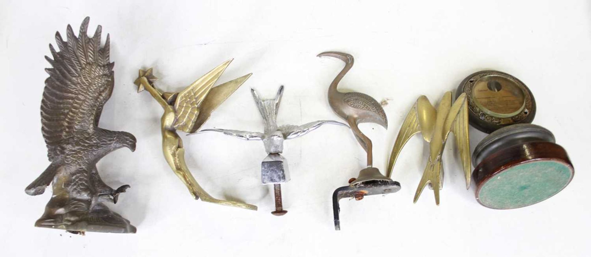 Assorted mascots, to include chrome eagle, brass winged female nude, brass bird of prey etc (6)