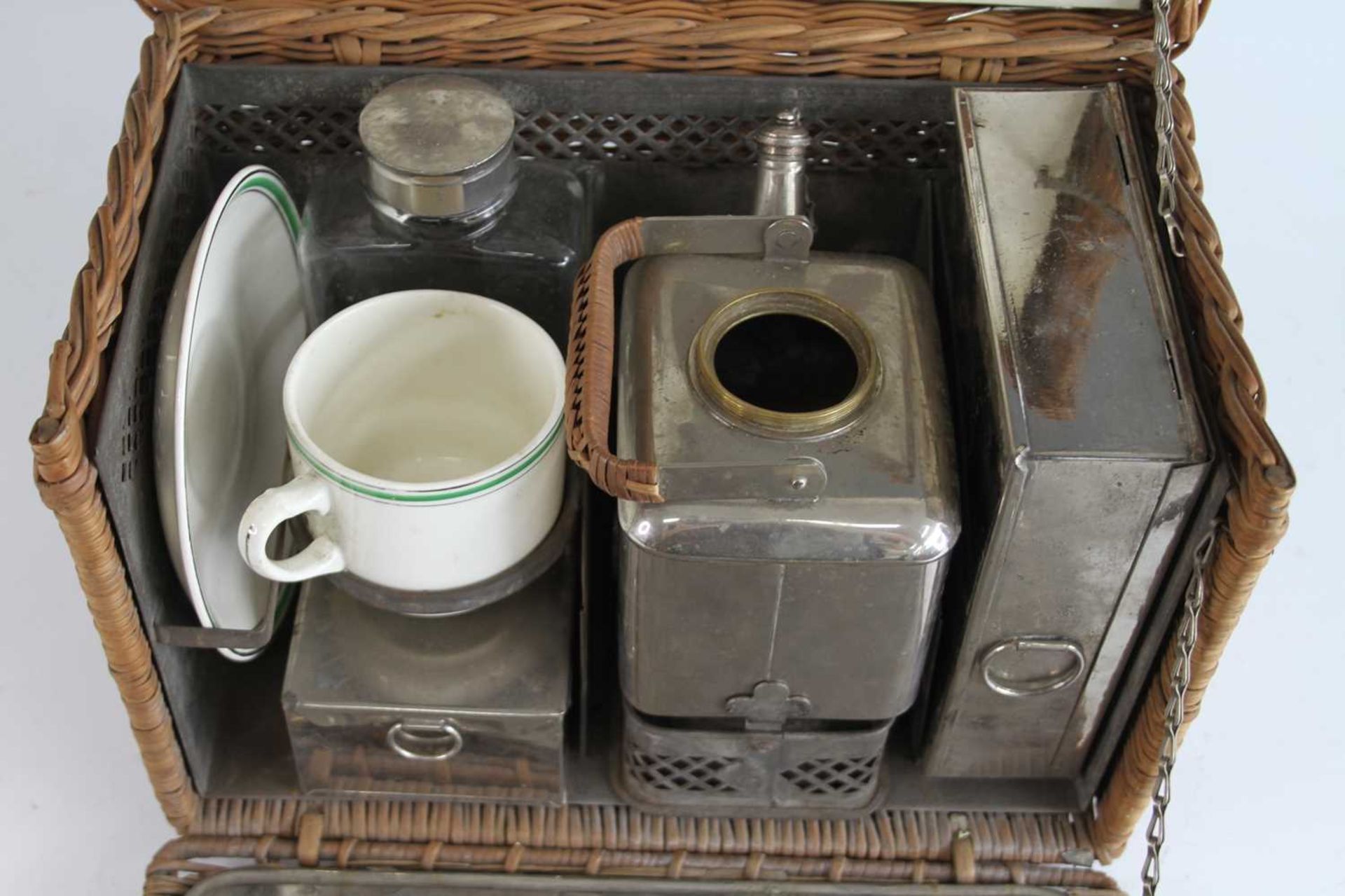 An early 20th century motorists wicker tea basket and contents, to include a spirit kettle, sandwich - Image 2 of 4