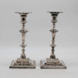 A pair of Mappin & Webb silver plated table candlesticks in the 18th century style, each having a