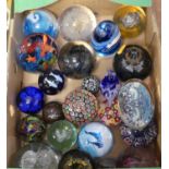 A collection of various glass paperweights, to include a millefiori example