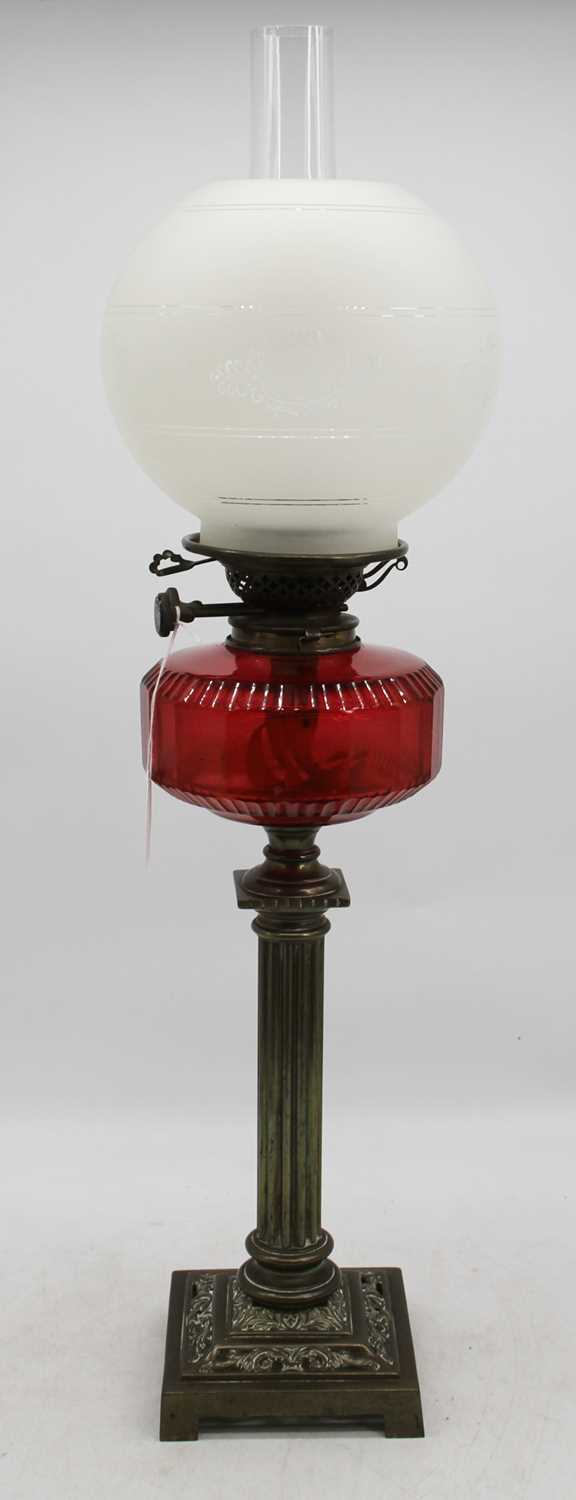 A Victorian oil lamp, having etched frosted glass shade, on Young's Patent burner and cranberry