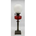 A Victorian oil lamp, having etched frosted glass shade, on Young's Patent burner and cranberry