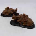 A pair of Chinese carved hardwood models of a young boy riding a water buffalo,height 12cm