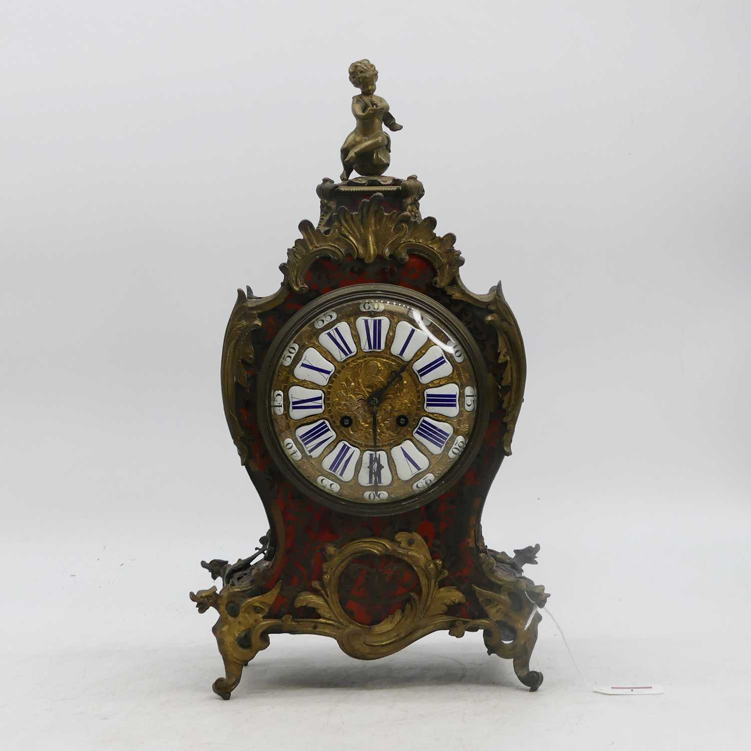 A 19th century French red tortoiseshell and boulle inlaid 8-day mantel clock, having enamelled Roman