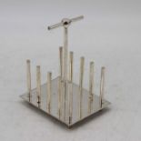 A silver plated toast rack, after the design by Dr Christopher Dresser, height 16cm