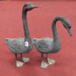 A pair of verdigris metal models of geese, each shown in standing pose, largest height 69cmThe