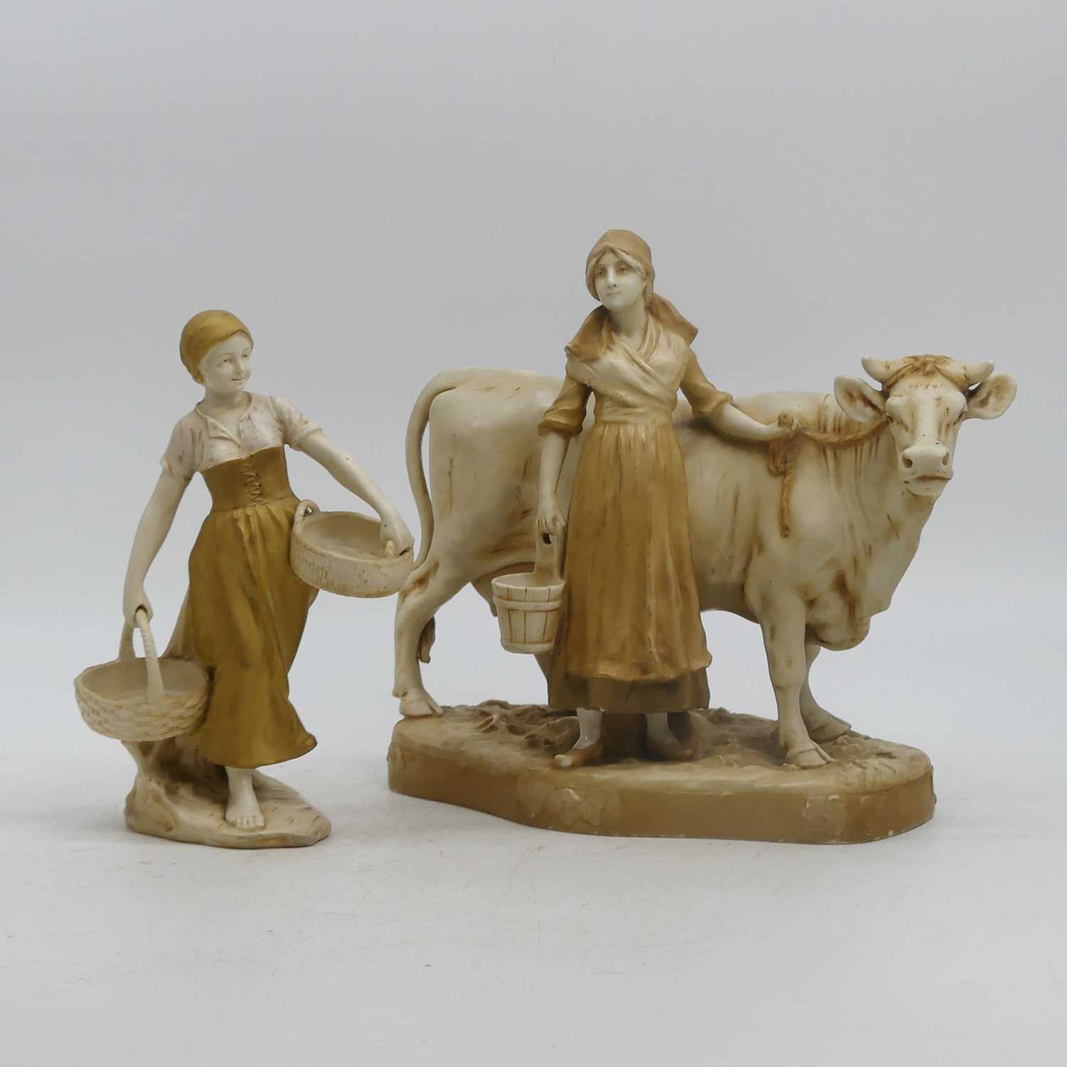 A Royal Dux figure of a milkmaid beside a cow, height 27cm, together with a similar Vienna figure,