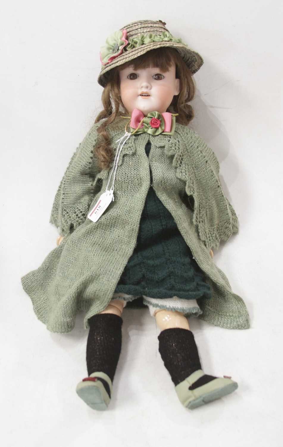 An early 20th century Armand Marseilles bisque head doll, having fixed brown eyes with painted