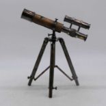 A reproduction brass telescope, mounted upon a tripod, height 31cm