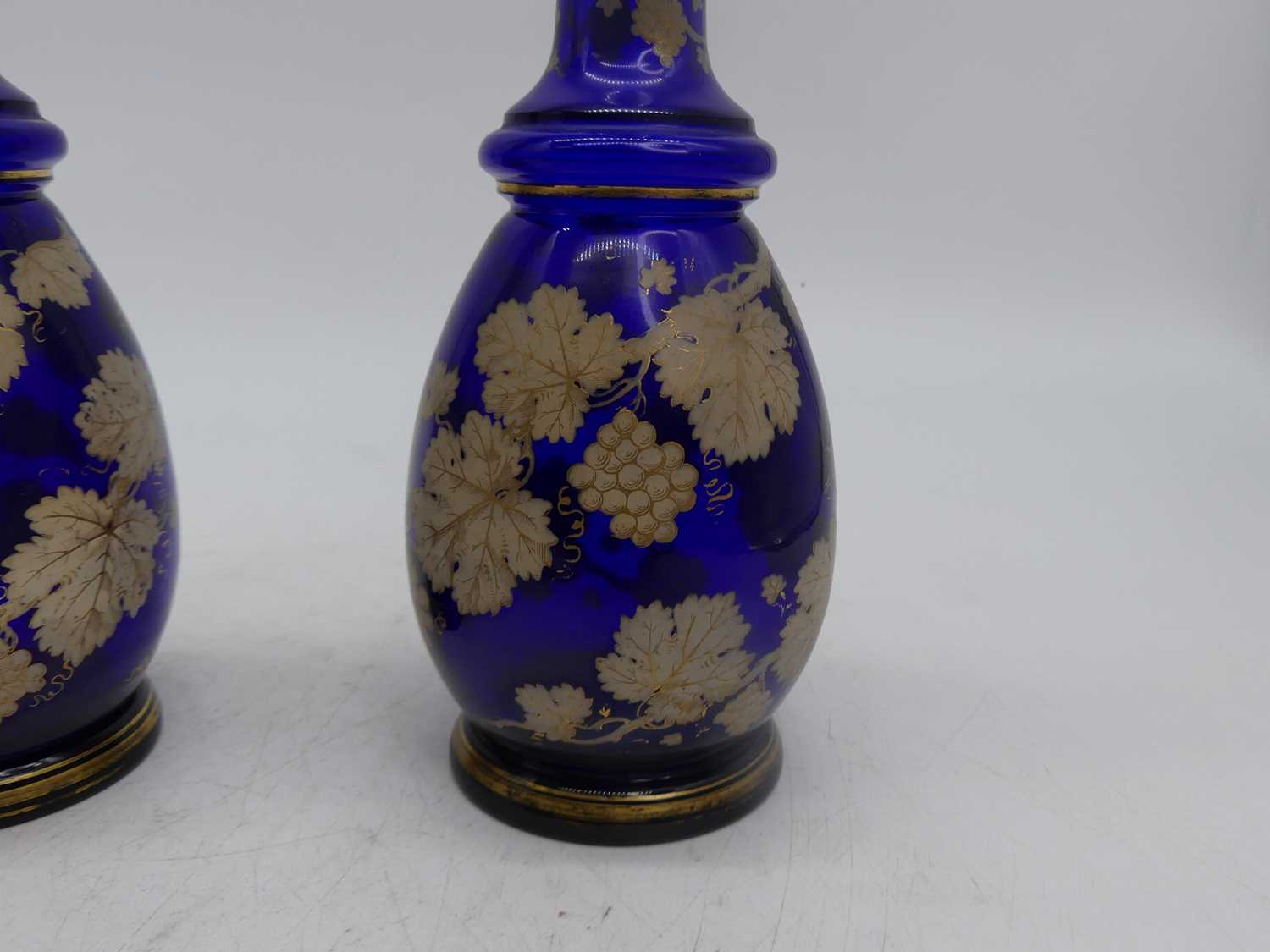 A pair of 19th century Bohemian style blue overlaid glass decanters, each decorated with trailing - Image 2 of 8