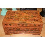 A Burmese red & black lacquered box, profusely decorated with figures, width 47cm