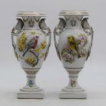 A pair of porcelain vases, each decorated with bird amongst flowers, height 28cm