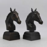 A pair of cast metal models of horse heads, height 30cm