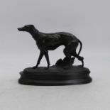 A spelter model of a greyhound, shown in standing pose, upon an ebonised plinth, height 19cm