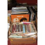 Two boxes of vintage vinyl 12" records and 7" singles, to include Dean Martin The Dean of Music, and