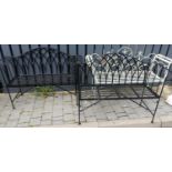 A pair of contemporary black painted wrought metal two seater folding garden benches, having lattice