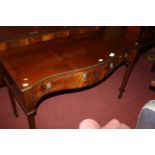 A reproduction mahogany serpentine front two drawer ledge back servery in the Regency taste, width