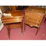 A mahogany nest of three occasional tables, raised on ring turned supports, the largest width