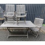 A contemporary faded and slatted teak garden patio suite comprising; X-frame rectangular table,